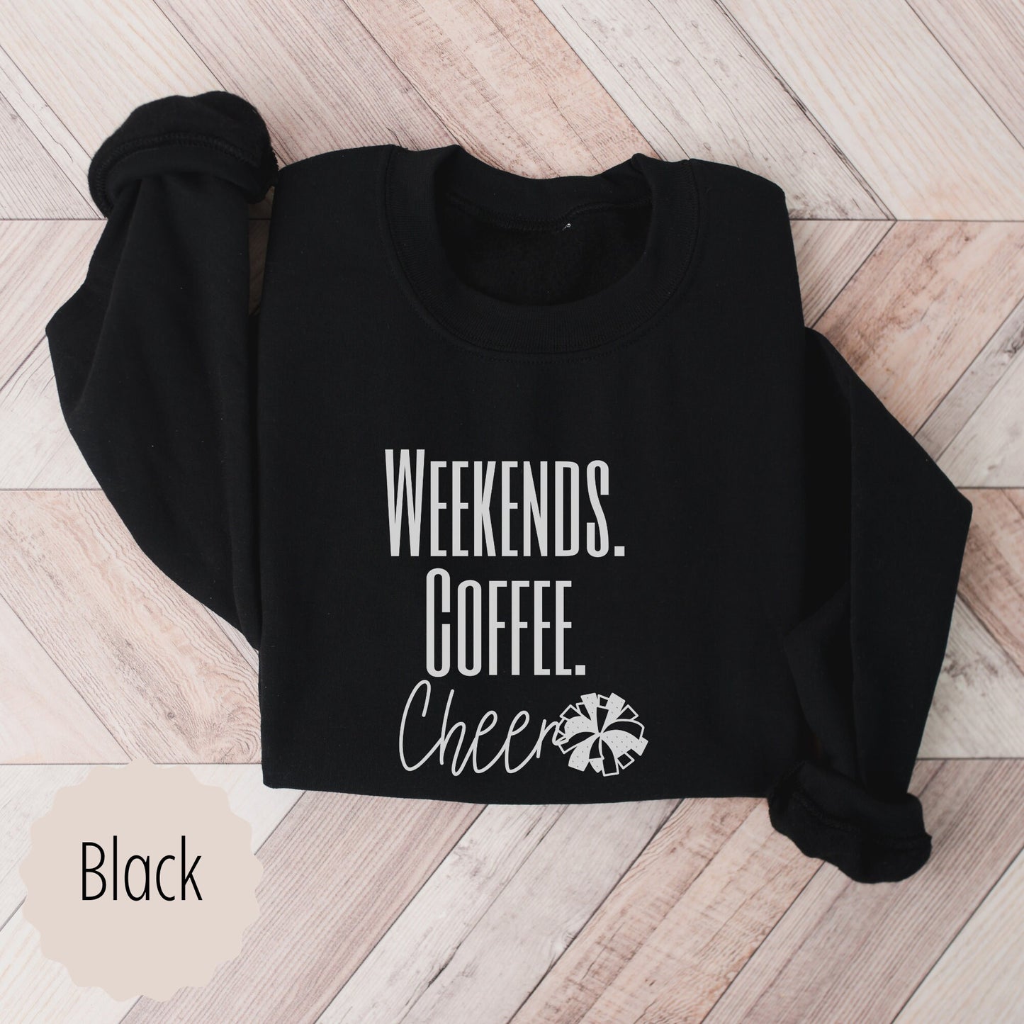 cheerleader crewneck for cheer lovers that says weekends coffee cheer with a pom pom. This is plain text lettering and the sweatshirt comes in the colors ash grey, black, sand, white, and dark heathered grey.