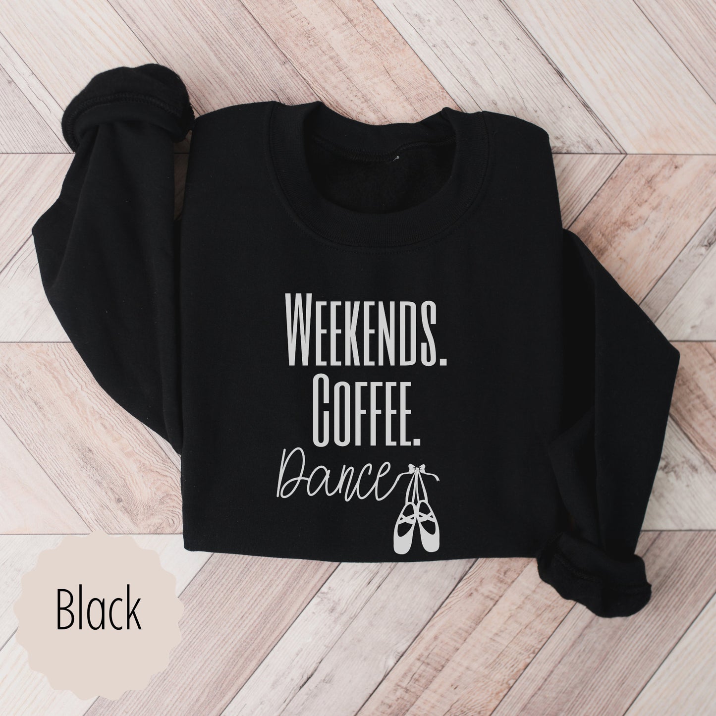 dance mama sweatshirt that says weekends coffee dance with ballet slippers after the word dance. This sweatshirt comes in sand, black, white, dark heathered gray, and ash gray.