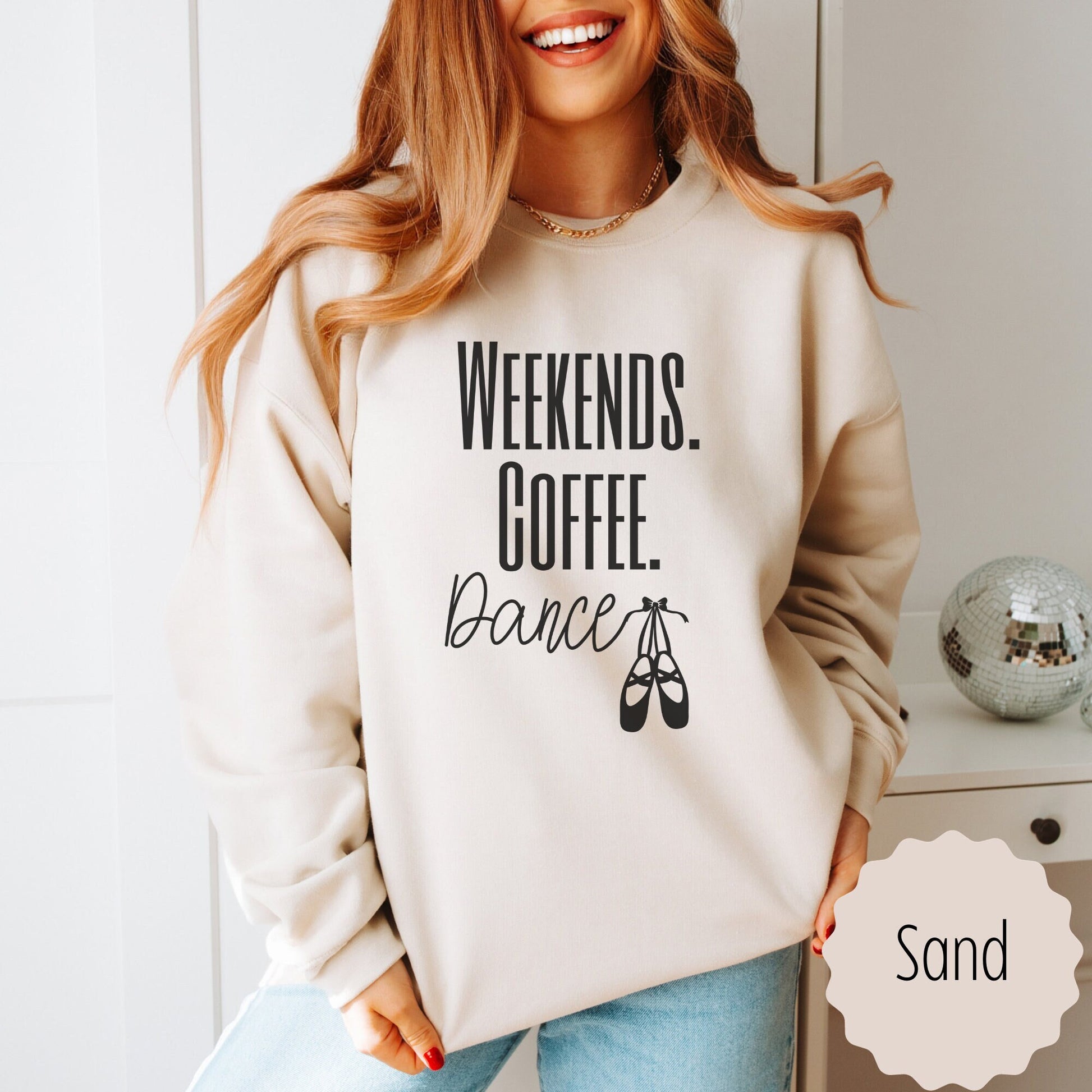 dance mom sweatshirt that says weekends coffee dance with ballet slippers after the word dance. This sweatshirt comes in sand, black, white, dark heathered gray, and ash gray.