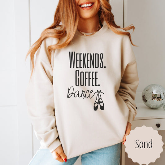 dance mom sweatshirt that says weekends coffee dance with ballet slippers after the word dance. This sweatshirt comes in sand, black, white, dark heathered gray, and ash gray.