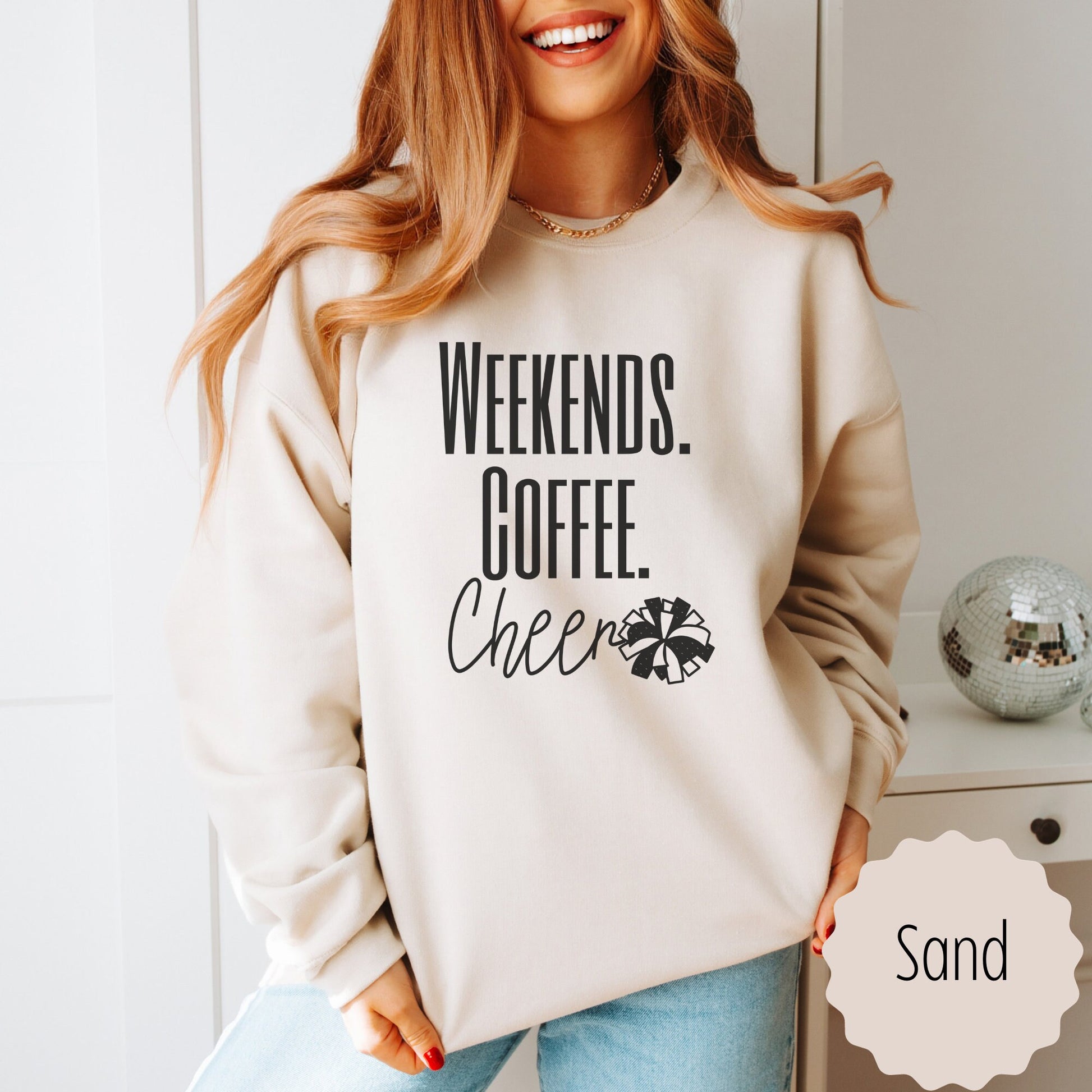 senior cheer mom sweatshirt that says weekends coffee cheer with a pom pom. This is plain text lettering and the sweatshirt comes in the colors ash grey, black, sand, white, and dark heathered grey.