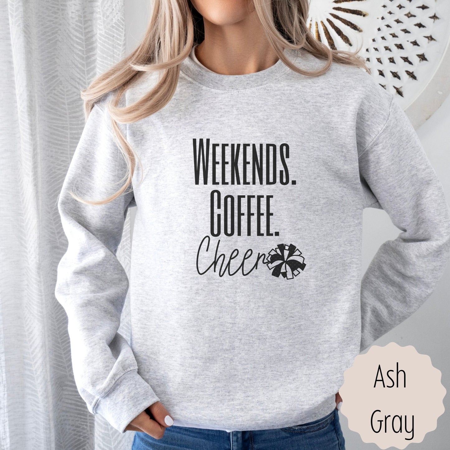 cheer coach gift sweatshirt that says weekends coffee cheer with a pom pom. This is plain text lettering and the sweatshirt comes in the colors ash grey, black, sand, white, and dark heathered grey.