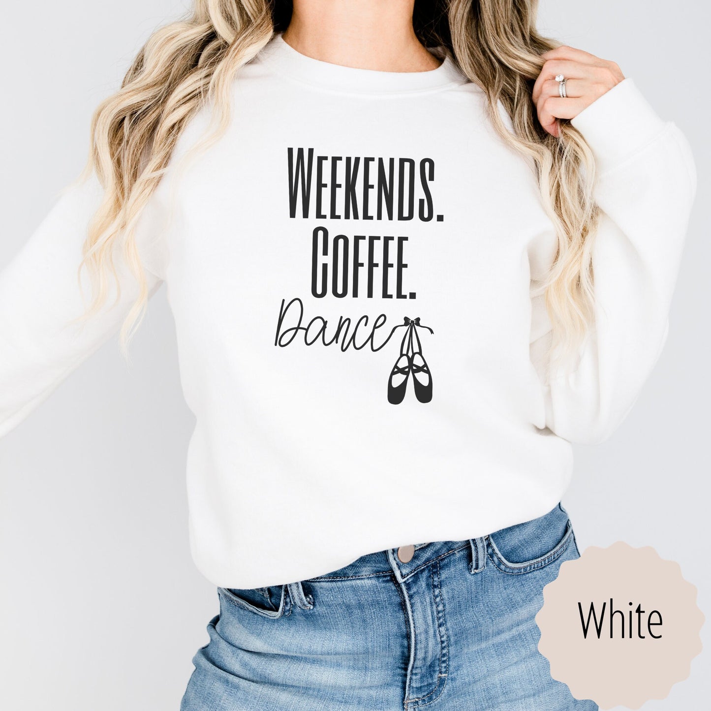 dance mom gift that says weekends coffee dance with ballet slippers after the word dance. This sweatshirt comes in sand, black, white, dark heathered gray, and ash gray.