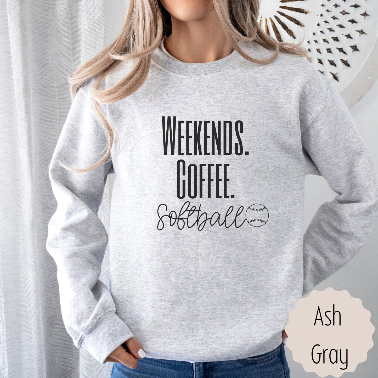 gift for sports mama for Moms that says weekends coffee softball with a black outlined softball on the bottom. This sweatshirt comes in sand, white, black, gray, and heareth dark gray.