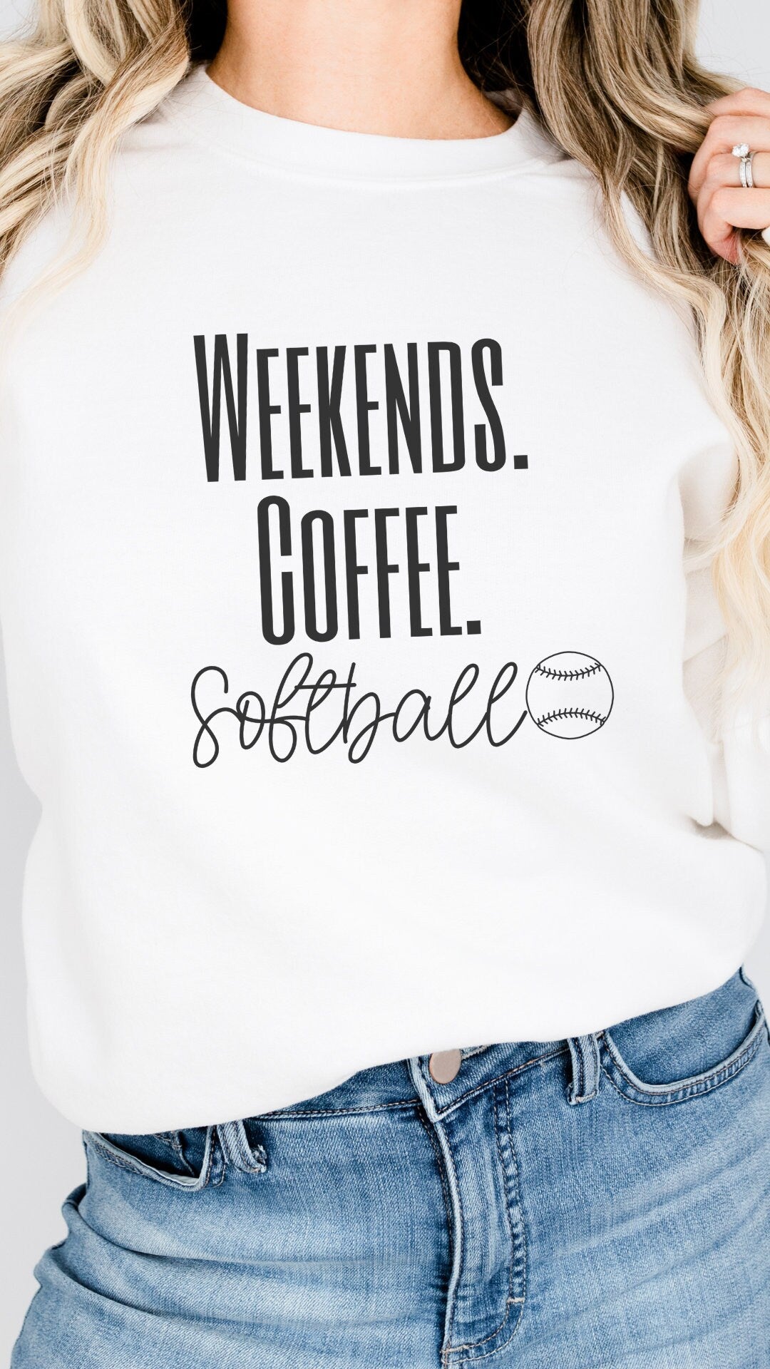 softball mama sweatshirt for Moms that says weekends coffee softball with a black outlined softball on the bottom. This sweatshirt comes in sand, white, black, gray, and heareth dark gray.