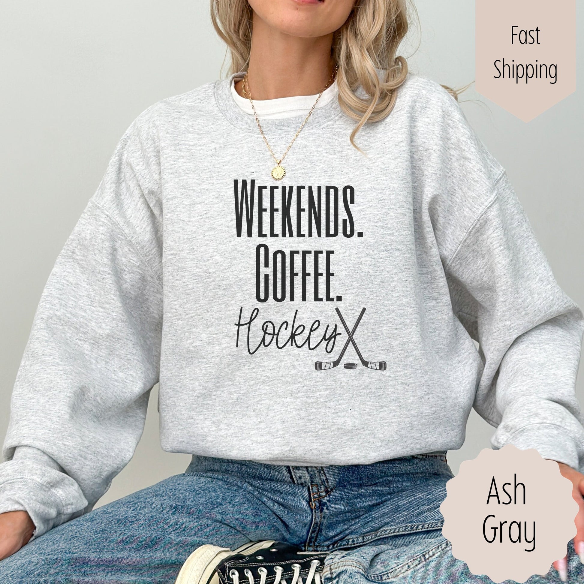 hockey coffee lover shirt that says weekends coffee hockey with a black outlined hockey sticks on the bottom. This sweatshirt comes in sand, white, black, gray, and heareth dark gray.